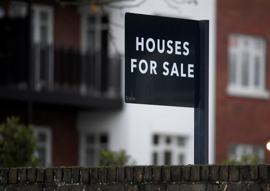 FILE PHOTO: Property sale signs are seen outside of a group of newly built houses in west London, Britain, November 23, 2017. REUTERS/Toby Melville/File Photo GLOBAL BUSINESS WEEK AHEAD